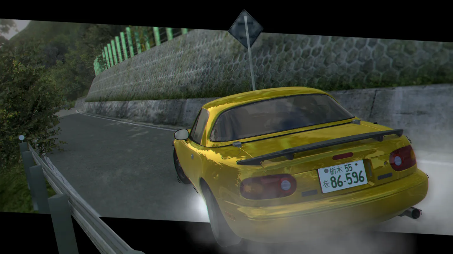 A gold Roadster NA6CE drifting past a stone wall