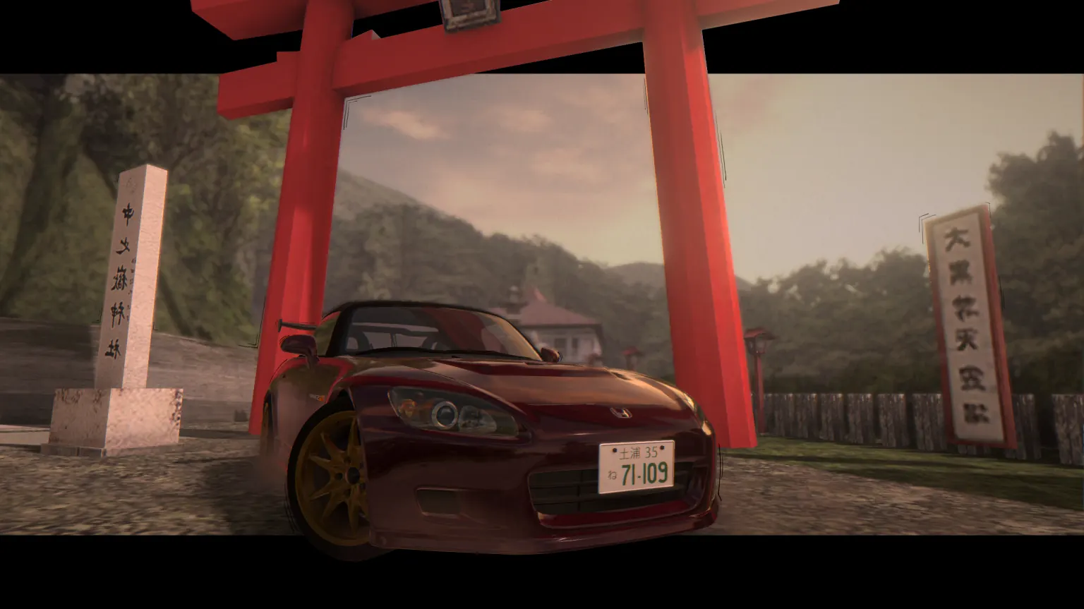 A red S2000 AP1 under a shrine gate on a mountain road
